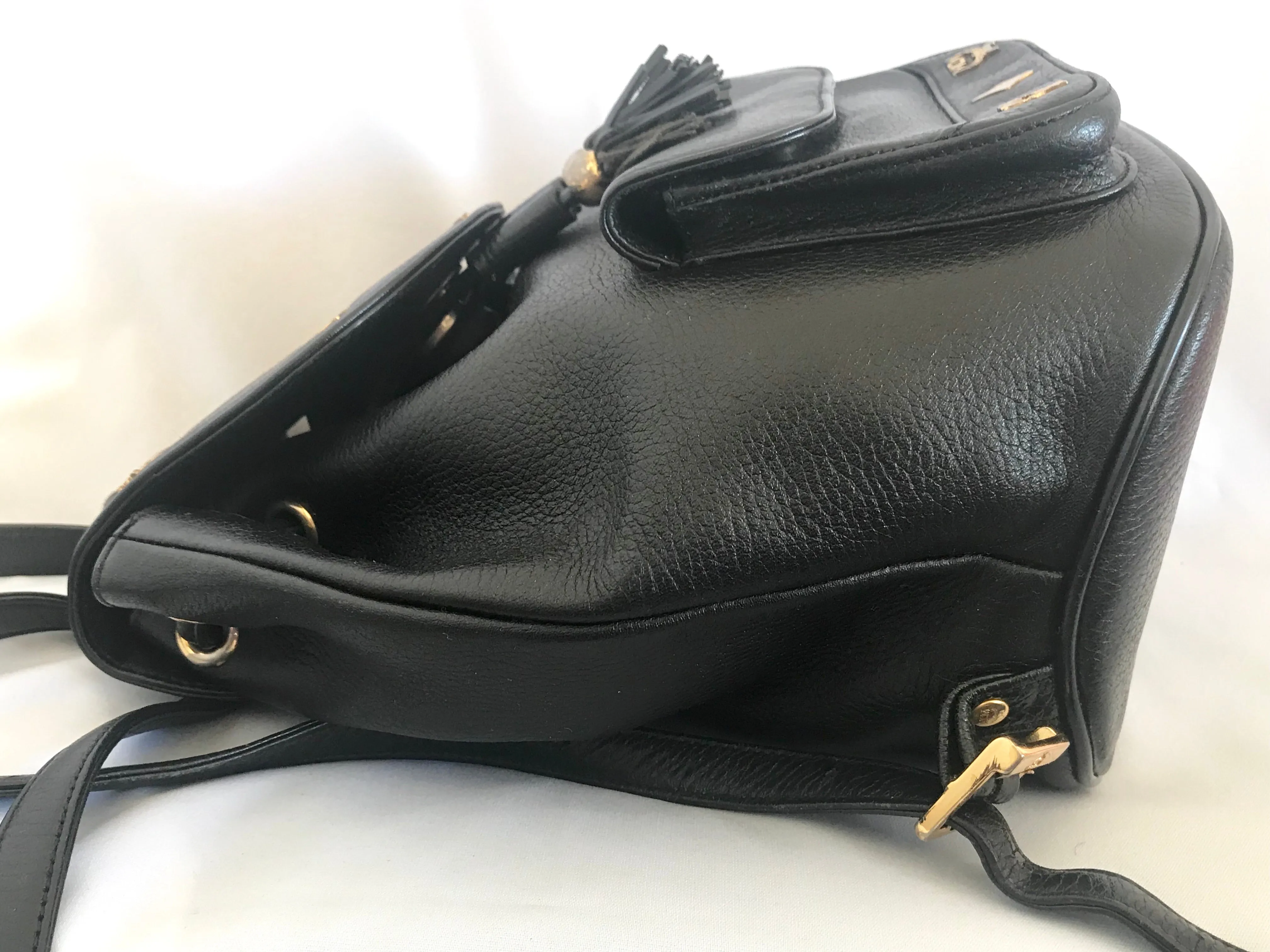Vintage MCM black backpack with golden studded logo motifs and drawstrings. Designed by Michael Cromer. Unisex bag for daily use.