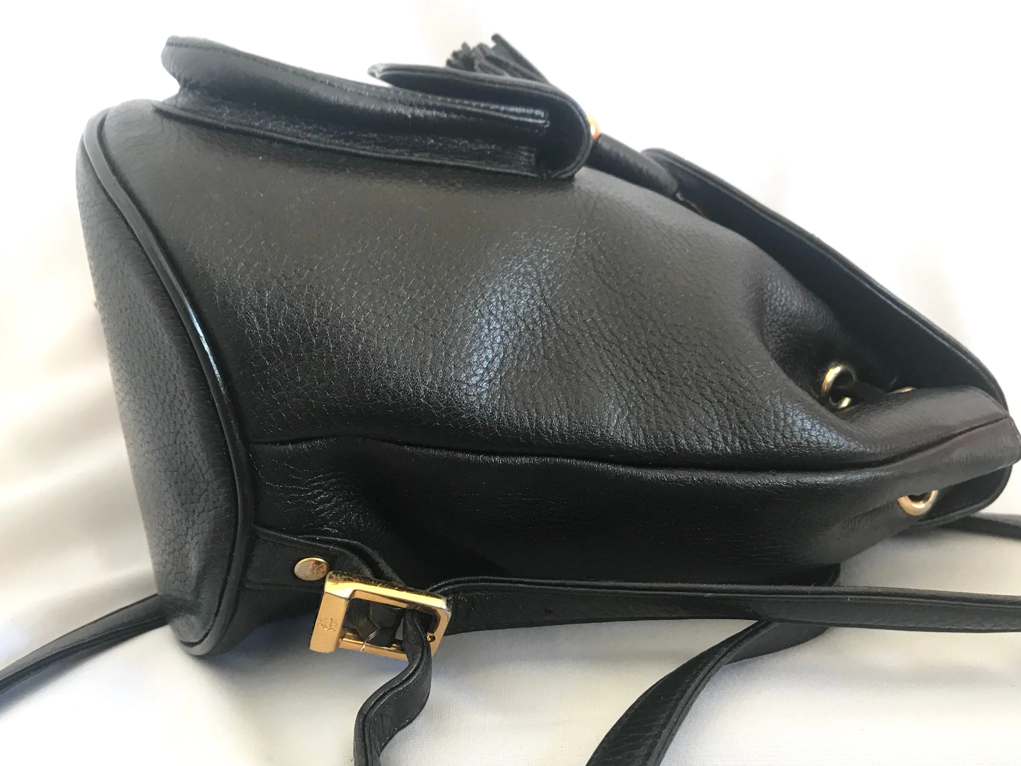 Vintage MCM black backpack with golden studded logo motifs and drawstrings. Designed by Michael Cromer. Unisex bag for daily use.